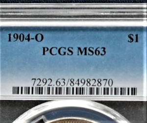 lot 889 image: 1904 O Morgan Silver Dollar - MS 63, Graded by PGCS. Choice Uncirculated.