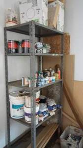 Four Shelf Metal Storage Unit With Miscellaneous Items On It