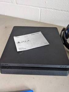 lot 191 image: Sony PlayStation 4 Slim 1TB Console Bundle with Headset, Dual Charging Dock and NBA 2K21