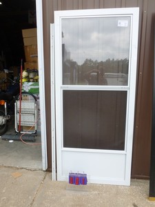 lot 1 image: Larson 36 combo screen door with hinge. No other jamb included. Unused. Has a few shipping scratches. As shown.