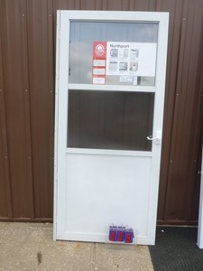 lot 5 image: Northport 36 combo screen door. Looks like it was a store display. Has hinge but no latch jamb. As shown.