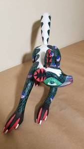 lot 99 image: Folk Art Skunk Sculpture by Tacinto Ramiyez