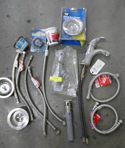 lot 123 image: Plumbers lot - faucet, sink baskets, hose, etc