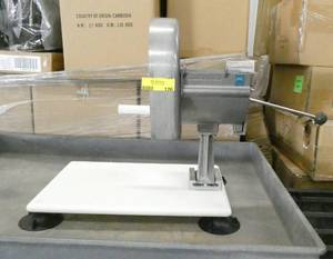 lot 126 image: Commercial Nemco slicer, attaches to a plastic cutting board with suction cups to adhere to the counter