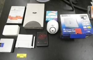 lot 138 image: Group of computer stuff, CD writer, small hubs, 250gb portable drive, usb floppy disk reader for 3-12 disks, air purifier, Apple HD Cinema adapter