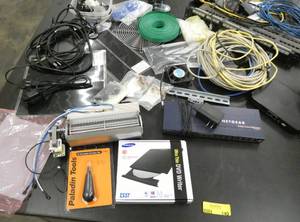 lot 140 image: Large lot of computer networking stuff, dvd writer, punch down tool, netgear switch, patch panels, long cables, internal cooling fan, wire, a couple of panels that Im not sure what they do