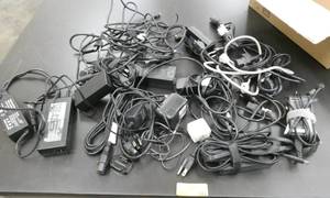lot 144 image: Box full of computer laptop power supplies and cords
