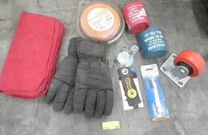 lot 170 image: New pair of thinsulate gloves size XL just dirty from storage, shop rags, door stop, weed whip line, wheel and some funny can cuzzies