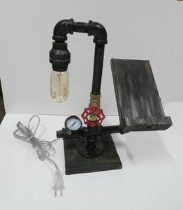 lot 184 image: Steampunk Bedside stand with a holder for your phonetabletbook.  Wood base, steel pipe, pressure gauge, the knob turns to turn on the Thomas Edison bulb