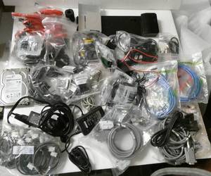 lot 192 image: Large lot of computer cables, ac adapters, drives, laptop docking station