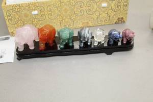 lot 912 image: Elephant Dcor 7-piece Set (in original decorative padded storage box)  with Wood Stand