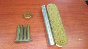 lot 101 image: WWI blank cartridges, brass buckle, brush and tube.