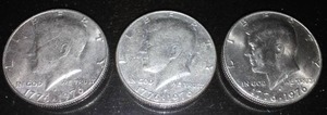 lot 240J image: 3 Kennedy 1976 (bicentennial) half dollar coins.
