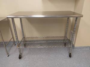 lot 1 image: MSRP $700 Medical NSF Grade Mobile Stainless Steel Surgical Instrument Table with Wire Rack On Wheels - Great Sturdy Condition With Signs Of Wear To Legs Etc - Suitable For Clinics, Laboratories, Kitchen, Restaurants & Food Production