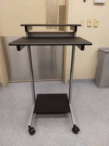 lot 9 image: MSRP $160 Uline&nbspMulti-Level Tilting Height Adjustable Sit Stand Computer Work-Station Podium Mobile Cart With Lower Printer Shelf - Black & Grey - Excellent Condition - ElectronicsContents Not Included