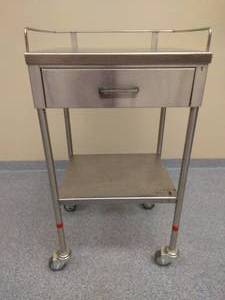 lot 13 image: MSRP $1000 Medical Grade Wilson&nbspStainless Steel Utility Table with One Drawer - All&nbspedges are bent and hemmed for added safety and rigidity - Built to last a lifetime Excellent Condition