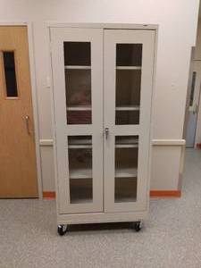 lot 28 image: MSRP$600 Uline Clear-View Mobile Storage Cabinet - 36 x 18 x 78, Tan...Cabinets roll easily for cleaning and rearranging workspace. With Key .....Great Condition