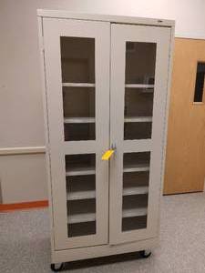 lot 28A image: MSRP$600 Clear-View Mobile Storage Cabinet - 36 x 18 x 78, Tan...Cabinets roll easily for cleaning and rearranging workspace. With Key .....Great Conditiont