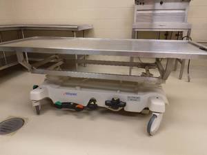 lot 44 image: WOWOW MSRP $10,000&nbspMopec&nbspHydraulic Dissection Cart Autopsy Table WStainless Steel Top -&nbspPurchased Less Than 6 Months Ago Like New Condition See PDF Spec Sheet For Details