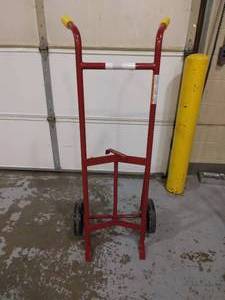 lot 54 image: MSRP$250 Steel-Frame Drum Hand Truck, Load Capacity 1,000 lb, 56 12 in x 23 12 in x 14 12 in...These hand trucks have a curved steel frame that cradles a drum as its being moved with the trucks