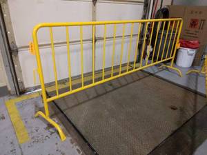 lot 57 image: MSRP $200 Yellow Powder Coated Steel Crowd Control Barrier - Easy To Move Around & Very Sturdy - Excellent Condition
