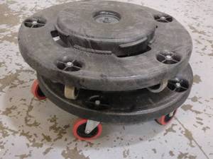 lot 126 image: MSRP $200 Lot Of 2&nbspRubbermaid FG264000BLA Round Plastic Trash Can Dolly w Raised Center & 250 lb Capacity - Good Condition