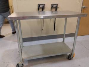 lot 83 image: MSRP $600 Medical NSF Grade Mobile Stainless Steel Surgical Instrument Table with Galvanized Steel Under Shelf On Wheels - Good Sturdy Condition - Suitable For Clinics, Laboratories, Kitchen, Restaurants & Food Production
