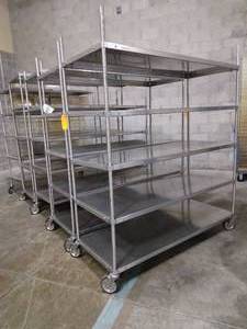 lot 98 image: WOW MSRP $12,000 Lot Of 5 Stainless Steel Mobile 5 Solid Shelves Storage Transfer Carts - Great Condition Contents Not Included