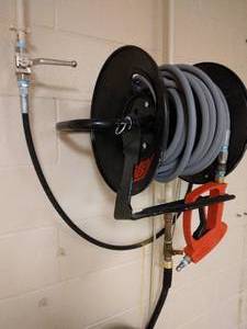 lot 116 image: Hotsy Pressure Washer Red Trigger Gun (Can handle 5000psi), Hose & Wall Mount Rack Only - Great Condition - No Pressure Washer Mechanism (Had been wired into building) 