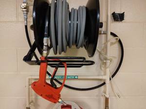 lot 118 image: Hotsy Pressure Washer Red Trigger Gun (Can handle 5000psi), Hose & Wall Mount Rack Only - Great Condition - No Pressure Washer Mechanism (Had been wired into building) 