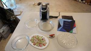 lot 144 image: Three Glass Pie Plates-One Round Glass Platter-White Platter With Apples & Apple Blossoms & Leaves On It-Electric Keurig Coffee Maker