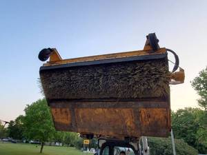 lot 19 image: Sweeper with dump bucket on universal skid steer mount