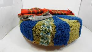 lot 26 image: Round (Hassock )  With Colorful Shag Cover On Four Casters--Clear Blow Up Seat Cushion--Red Plaid Seat Cushion W Matching Cover-Up  Blanket