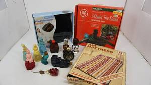 lot 77 image: Polarized G.E. Indoors 3-Outlet Tree Stand For Artificial Trees--The Hampton Double Size Air Mattress-Item #995--Health Touch Foot Massager (Vibration)--Eleven Avon Perfume Decanters