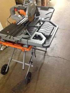 lot 1 image: RIGID 15 Amp 10 in. Tile saw With stand  IN WORKING CONDITIONS SEE PIC