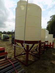 lot 9 image: Cone Bottom Poly Tank and Stand with valve & Piping