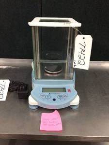 lot 10 image: WOW MSRP$1800 OHAUS AV64 Adventurer Pro Analytical Balance Scale - incorporates a frameless draftshield design for easy access and cleaning - Good Working Condition - Door Stops On Both Sides Have Broken Off So Tape Is Used To Keep Them Shut
