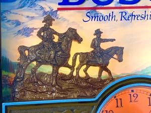 lot 227 image: Vintage Busch Beer Lighted Clock w Dimensional Cowboys and Mountain Scene