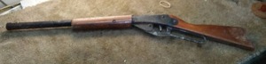 lot 136 image: Daisy BB gun. Wood and metal, safety on trigger.