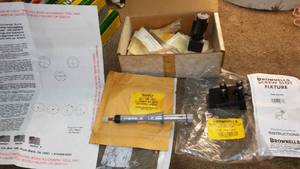 lot 157 image: 3 items - Brownells Screw Slot Fixture, Universal Big Bore Arbor and Screw Slot Fixture.
