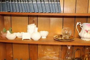 lot 774 image: Lot of (Approximately 12) Table Dcor (on shelf)  - Milk Glass Vases, Bowls and Candy Jars, Green and Pink Rooster Candy Bowl, Glass Dcor, Ceramic Pitcher, Decorative Plates
