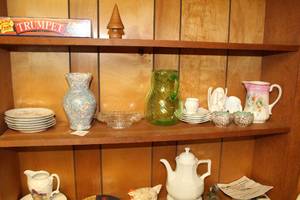 lot 777 image: Lot of (Approximately 20) Table Dcor (on shelf)  - Green Glass Pitcher, Plates, Saucers, Glass Bowl, Ceramic Vase, Ceramic Pitcher and more