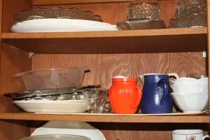 lot 807 image: Kitchenwares (on middle shelf)  with Serving Platters, Creamers, Ice Cream Bowls, Wine Glasses