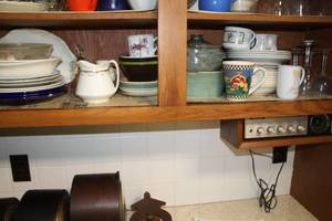 lot 808 image: Kitchenwares (on bottom shelf)  with Plates, Serving Dishes, Wine Glasses, Mugs