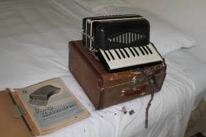 lot 831 image: Amati Accordion  with Sheet Music and Case