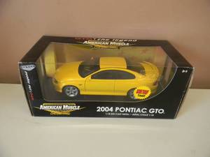 lot 3 image: 118 SCALE DIE-CAST - AMERICAN MUSCLE 2004 PONTIAC GTO. NEW IN BOX. GREAT PIECE - SEE PICTURES.
