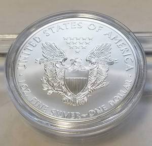 lot 62 image: 2013 AMERICAN SILVER EAGLE 1 TROY OZ. .999 FINE SILVER IN AIRTITE