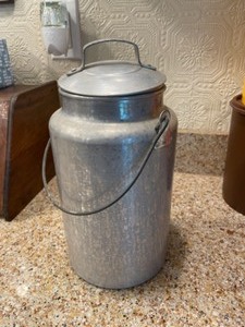 lot 81 image: Aluminum Canister with lid and artificial flowers