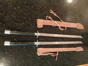 Two Swords with Black Handles