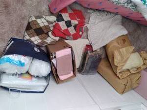 lot 46 image: Large Lot of Material, (2) Eaton Sweaters, and (2) Batches of Wool for a Spinning Wheel